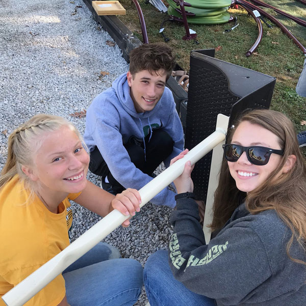 3 students building playground