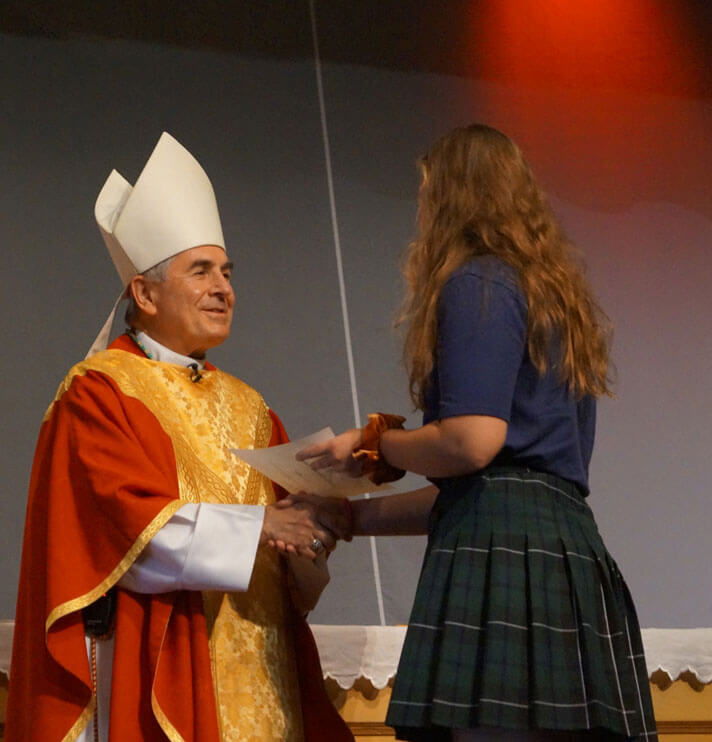 bishop presenting female student award