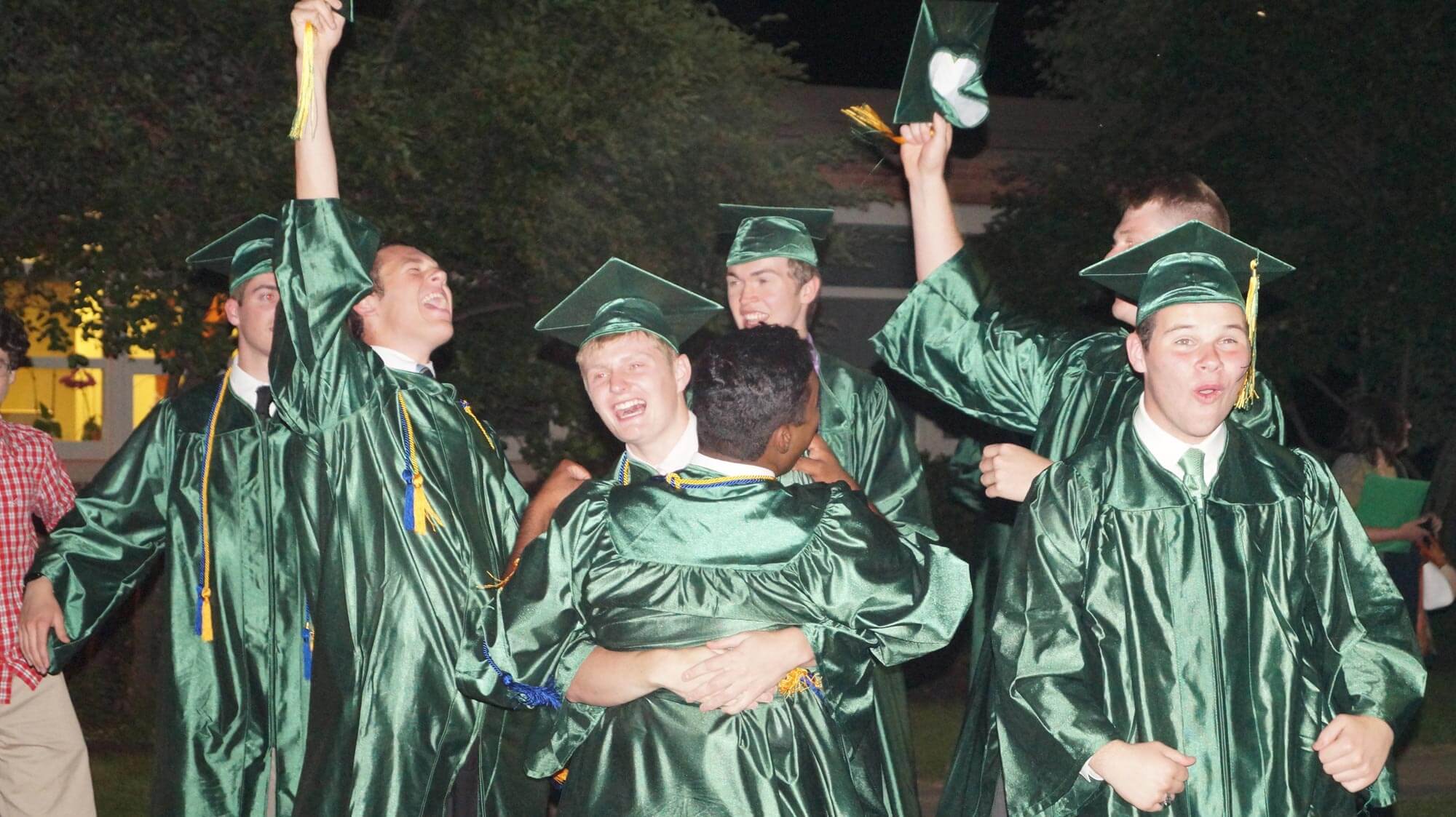 student graduates celebrate in cap and gowns