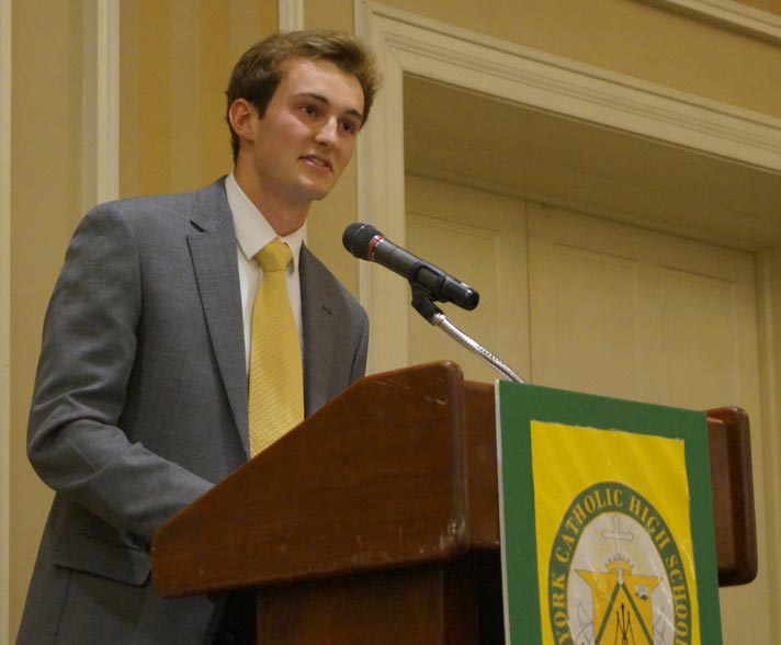 male student speaking at podium