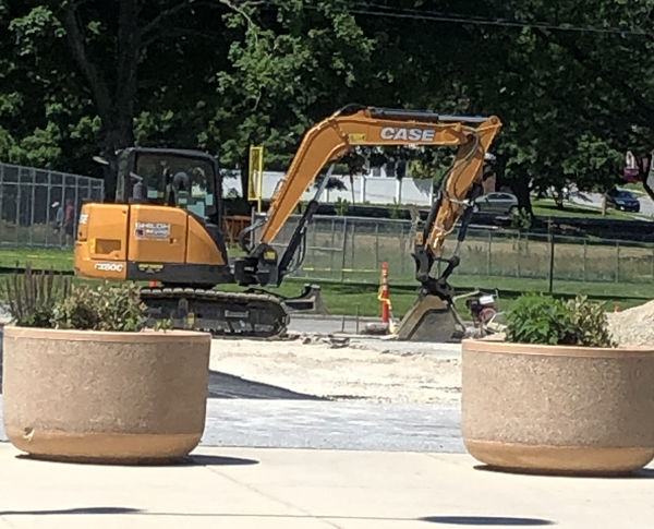 bulldozer digging in parking lot