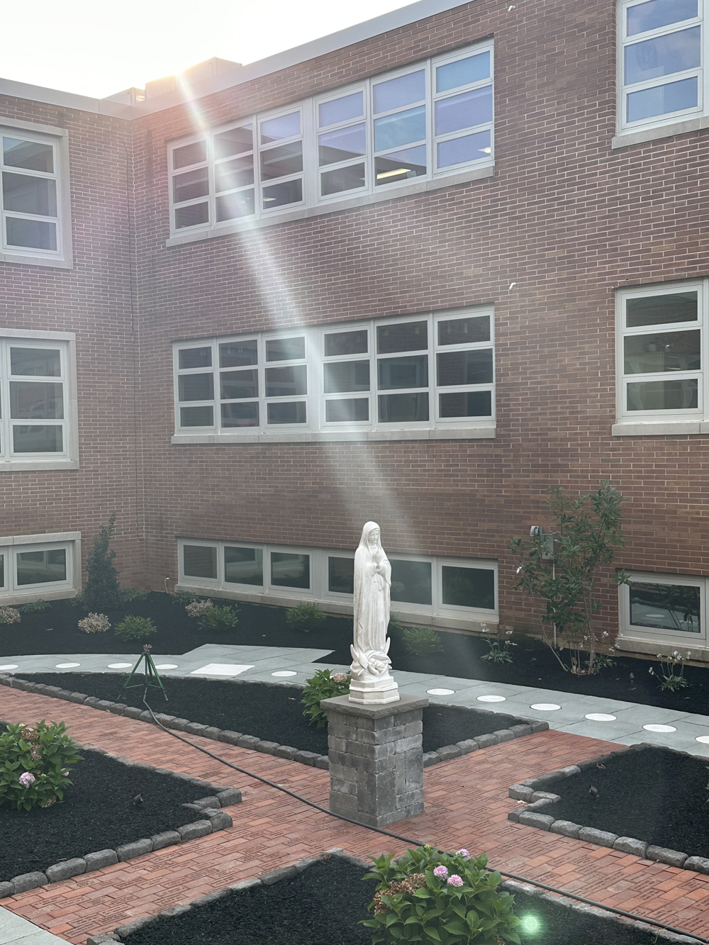 sunrays-shining-on-statue-of-Mary-in-Rosary-Walk