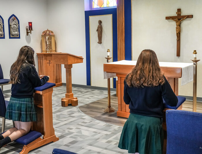 2-females-kneeling-in-prayer-in-chapel