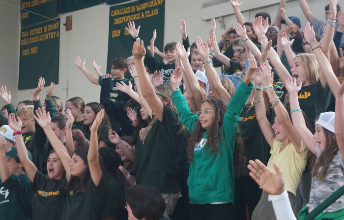 students-excited-with-hands-up-at-pep-rally