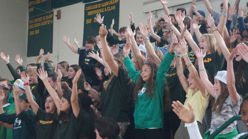 students-excited-with-hands-up-at-pep-rally