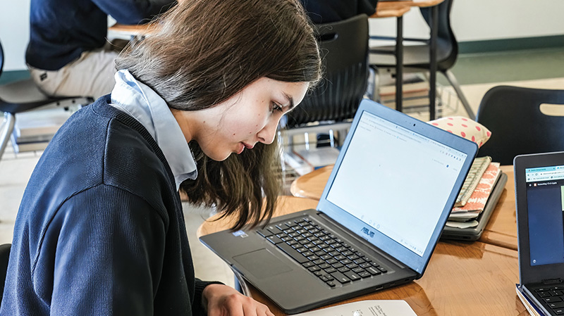 Female-student-at-desk-with-laptop