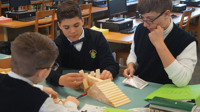 Students collaborating at table in classroom