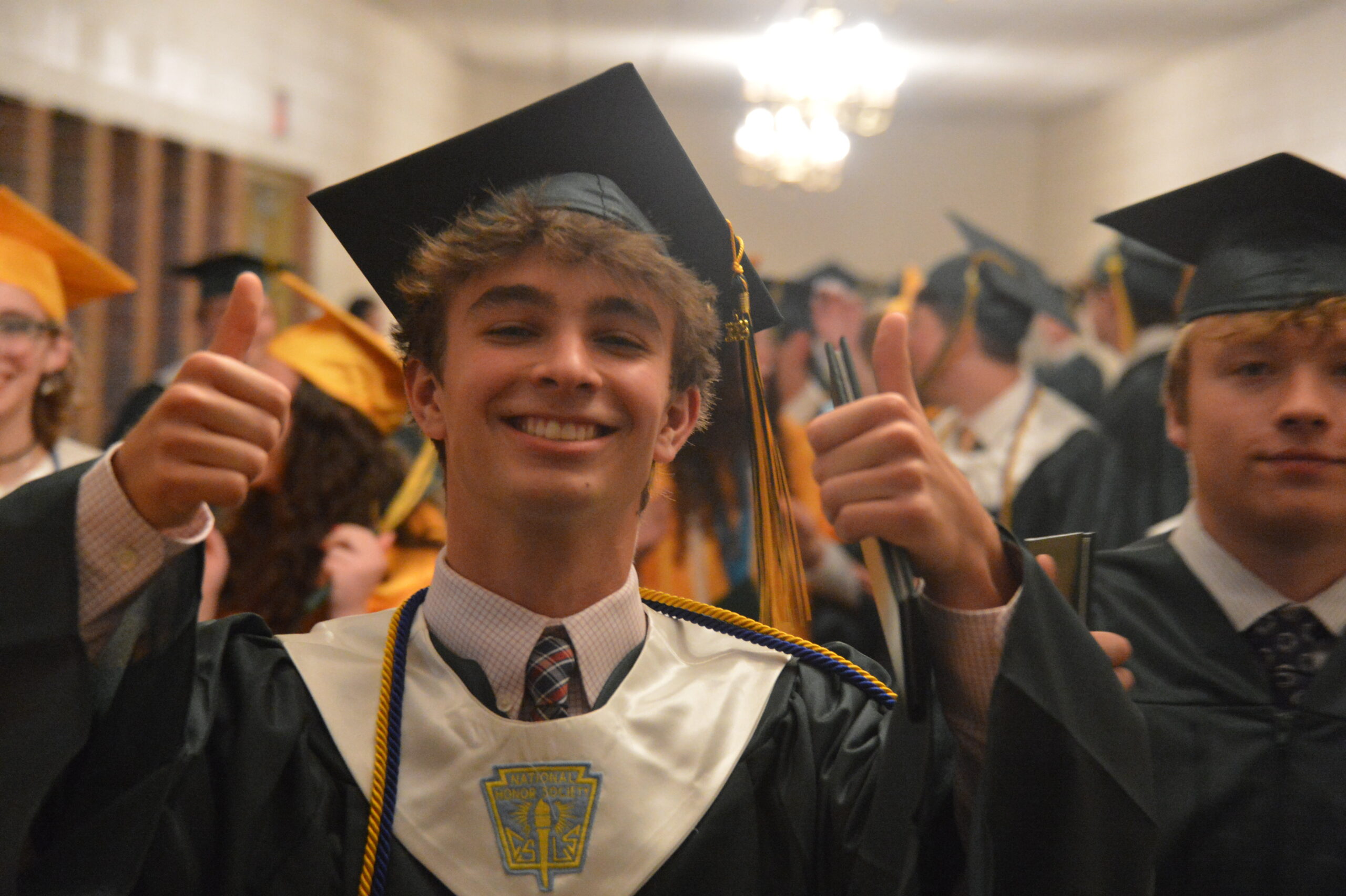 male graduate giving thumbs up