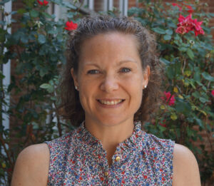 Headshot of Admissions Director, Christina Lee, in front of rose bush.